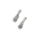A pair of diamond drop earrings, the pear shaped diamonds are set within a surround of eleven