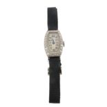 An early 20th century diamond-set ladies wristwatch, the tonneau-shaped diamond with black Arabic