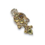 An Arts and Crafts brooch attributed to Dorrie Nossiter, set with zircons and sapphires in silver