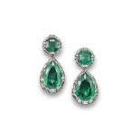 A pair of emerald and diamond drop earrings, each pair shaped emerald is set within a surround of