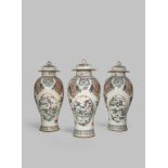 THREE CHINESE FAMILLE ROSE BALUSTER VASES AND COVERS MID 18TH CENTURY Brightly enamelled with