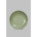 A MASSIVE CHINESE LONGQUAN CELADON DISH YUAN/EARLY MING DYNASTY Robustly potted, the centre