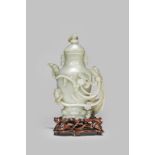 A LARGE CHINESE CELADON JADE EWER AND COVER QIANLONG 1736-95 The baluster-shaped body raised on a