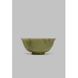 A CHINESE MOTTLED GREEN JADE BOWL SIX CHARACTER QIANLONG MARK AND OF THE PERIOD 1736-95 The plain