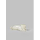 A CHINESE WHITE JADE CARVING OF A MYTHICAL BEAST QING DYNASTY OR LATER Reclining with its head