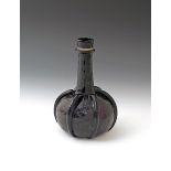 An amethyst glass decanter 18th century, of bottle form with a long tapering neck issuing from a