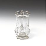 A tall glass mug dated 1788, the base moulded with a row of gadroons above a scalloped foot, the
