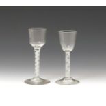 Two wine glasses c.1760-70, one with a rounded funnel bowl, the other with an ogee bowl, both raised