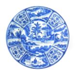 A Frankfurt faïence dish early 18th century, painted in blue in the Kraak manner with two Chinese