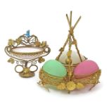 A Continental trinket or bonbon stand 19th century, formed as three opaque coloured glass eggs in