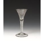 A wine glass of Jacobite significance c.1760, the drawn trumpet bowl engraved with a six-petalled