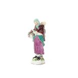 A miniature Chelsea figure of a mother and child c.1753-55, the rustic lady wearing a green