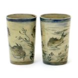 A pair of Martin Brothers stoneware Aquatic beakers, dated 1888, flaring cylindrical form, incised