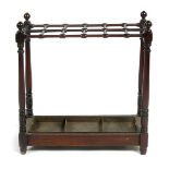 An Aesthetic Movement mahogany stickstand, with metal drip tray, rectangular form with turned