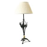 A W.A.S Benson wrought iron table lamp, on arched tripod foot with foliate panels the central stem