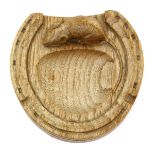 A Robert Mouseman Thompson oak ashtray, modelled as a horseshoe, with carved mouse signature, 12.