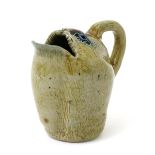 A small Martin Brothers stoneware spoon-warmer jug by Edwin & Walter Martin, modelled as an open-