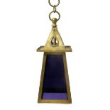 A brass hall lantern, tapering square section with triangular terminal pierced and modelled with