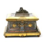 A polished and patinated bronze casket, rectangular section, the hinged cover set with sphinx