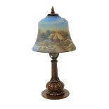 A Miller patinated metal table lamp and reverse painted glass shade, the bell shaped shade painted