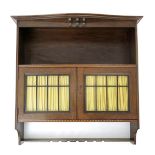 A P.E. Gane oak wall cabinet, rectangular with leaded glazed doors between two open shelves, the