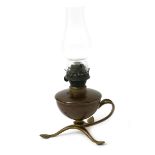 A W.A.S. Benson copper and brass oil lamp, the copper reservoir on tripod foot with foliate feet and