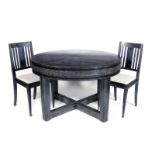A continental Secessionist limed and ebonised oak extending dining table and six chairs, the round