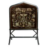 An ebonised wood fire screen in the manner of J.P. Seddon, on angled feet, the uprights with