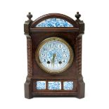 An Aesthetic Movement oak mantel clock in the style of Lewis F Day, rectangular form with domed