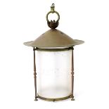 A brass hall lantern, the pierced domed top supporting a cylindrical frosted glass shade,