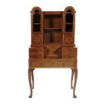 A Cotswold school walnut cabinet on stand by Alfred James, dated 1927-28, serpentine legs supporting