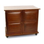 ]A modern Cotswold School mahogany cabinet, on castors, rectangular section with panelled doors