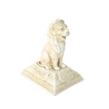 A Leeds Fireclay Co advertising paperweight, modelled as a seated lion, the base with shields