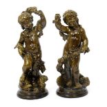 A rare pair of Burmantofts Faience architectural figures of putti, one modelled standing by a