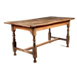 An oak farmhouse kitchen table, the twin plank top with cleated ends, on turned and block supports