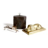 An early 19th century tôle tea caddy, a brass paperweight in the form of a recumbent lion