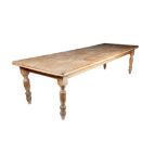 A large Victorian pitch pine farmhouse kitchen table, the detachable top with a moulded edge on