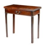 An early George III mahogany tea table, the solid top above a frieze drawer, with a cast brass swing