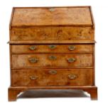 A Queen Anne walnut bureau, in two sections, cross and feather banded, the front with burr