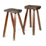 Two 19th century oak and elm primitive dairy stools, each on chamfered supports, 60.2cm high, 33.5cm