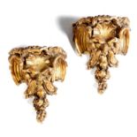 A pair of 19th century giltwood and gesso corbels, each modelled in the form of a grotesque head