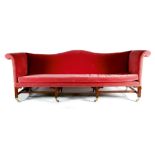 A large pair of George III style mahogany sofas, each upholstered with plush fabric, with a