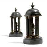 A pair of late 19th century continental black marble and gilt brass models of classical temples,