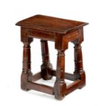 A 17th century oak joined stool, the seat with moulded and carved thumbnail edges and incised zigzag