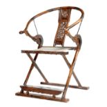 A Chinese hardwood and metal mounted folding armchair, the ox-bow back above a pierced splat