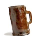 An 18th century leather mug or blackjack, stamped with initials 'S T J', 17cm high. Provenance: