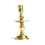 A mid 17th century Dutch brass Heemskerk candlestick, with a pierced nozzle, a turned and knopped