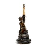 A French bronze figural lamp base, modelled with a scantily clad young maiden seated beside a