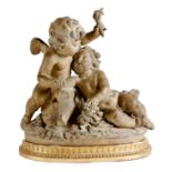 A patinated terracotta group of Cupid and Psyche as cherubs, signed 'Fernandez', on an associated