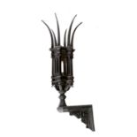 An iron lantern in Gothic revival style, with six spiked finials, above arches and columns with a